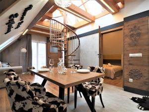 - une salle à manger avec une table et des chaises en bois dans l'établissement VIP Apartamenty ROYAL SPA, à Zakopane