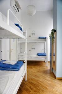 a room with three bunk beds in a room at Grand Hostel Manin in La Spezia