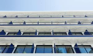 a facade of a building with blue windows at H10 Porto Poniente 4* Sup in Benidorm