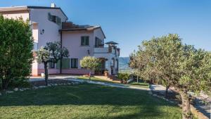 a large white house with trees in front of it at La Dolce Vista Bed&Breakfast in Cannara
