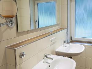 a bathroom with two sinks and a mirror at Hoferpeterhof in Bad Peterstal-Griesbach