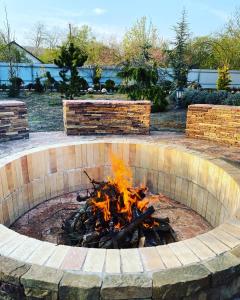 a fire pit in a yard with flames in it at Guesthouse Saksonia in Goryachiy Klyuch