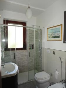 a bathroom with a shower and a toilet and a sink at Sardinia Holidays - Domus Patrizia in Quartu SantʼElena +23 photos