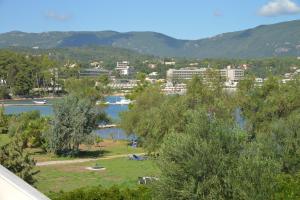 a view of a city with a lake and mountains at Saint Nicholas Beach Resort in Dassia