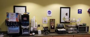 a kitchen counter with various appliances on a wall at Microtel Inn & Suites by Wyndham Delphos in Delphos