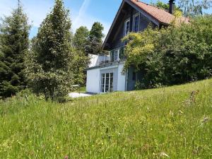 a house on a hill with a field of grass at Haus ingrid in Lochau