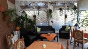 a living room with chairs and tables and a couch at Hotel Amselhof in Bispingen