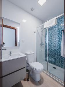 a bathroom with a toilet and a sink and a shower at Nature Madeira Guest House in Porto da Cruz