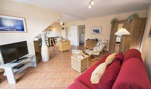 Et tv og/eller underholdning på Ferienwohnung Strandperle