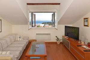 a living room with a couch and a tv at Apartment FRANKA in Split