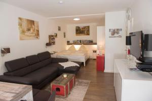 a living room with a couch and a bed at App 624 Panoramic Hohegeiß Terrassenhaus in Braunlage