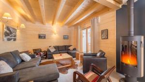 a living room with a couch and a fireplace at Le Ciste - Chalet - BO Immobilier in La Chapelle-dʼAbondance