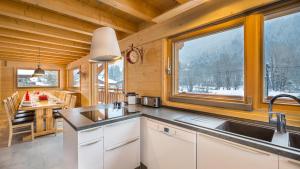 a kitchen with a sink and a table in a cabin at Le Ciste - Chalet - BO Immobilier in La Chapelle-dʼAbondance