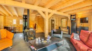 a living room with a couch and a table at Les 4 Chamois - Chalet - BO Immobilier in Abondance