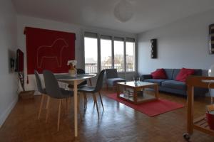a living room with a table and a couch at chanteraine 2 in Reims