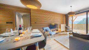 Un comedor con una mesa con copas de vino. en Les 360 - Apt 2 - BO Immobilier - Châtel- remises sur les forfaits de skis Châtel ou Portes du soleil, en Châtel