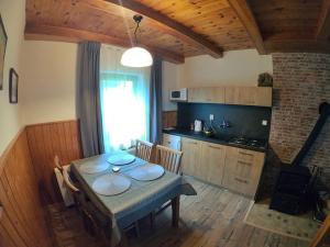 a kitchen and dining room with a table and chairs at Apartmán U Sjezdovky in Železná Ruda