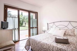 a bedroom with a bed and a sliding glass door at La Dolce Vista Bed&Breakfast in Cannara