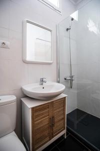 a white bathroom with a sink and a mirror at Cotillo Sea 2 in Cotillo