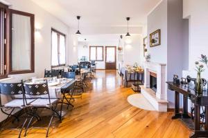 a dining room with tables and chairs and a fireplace at La Dolce Vista Bed&Breakfast in Cannara