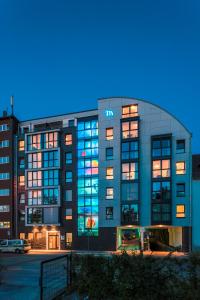 a large building with a m building at Mintrops Concierge Hotel in Essen