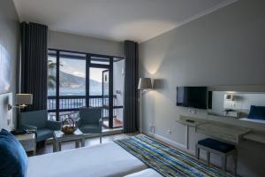 a hotel room with a view of the ocean at Estalagem do Mar in São Vicente