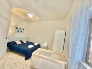 a bedroom with a bed with a blue blanket at Lulù Marin Casa Vacanze Praia a Mare in Praia a Mare