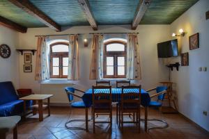 a dining room with a table and chairs at Penzion Čas in Český Rudolec