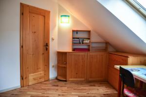 a room with an attic with a wooden door at Penzion Čas in Český Rudolec