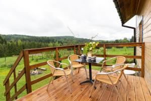 a patio with a table and chairs on a deck at Domek Na Polanie in Budzów