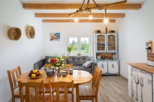 a kitchen and living room with a wooden table at Domek Na Polanie in Budzów