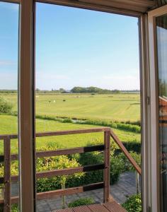 a view of a field from a window at 't Wapen van Middelie in Middelie