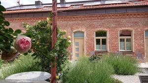 a garden in front of a brick building at Maison am Liesingbach in Vienna