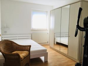 a bedroom with a mirror and a chair and a bed at Ferienhaus Zerrer in Zarrendorf