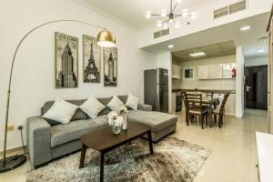 a living room with a couch and a table at Primestay - Beautifully Furnished Studio near the Metro in Dubai