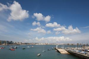 a group of boats in the water near a harbor at Villa Cascais Boutique Hotel in Cascais