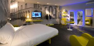 
a hotel room with two beds and a television at The Street Milano Duomo | a Design Boutique Hotel in Milan
