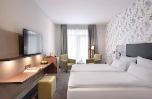 a hotel room with two beds and a television at Sympathie-Hotel Fürstenhof in Bad Kreuznach +51 photos