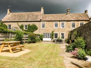 a house with a picnic table in front of it at Hall Cottage in Richmond