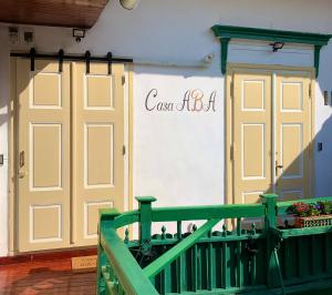 a building with two doors and a sign on it at Casa ABA in Sibiu
