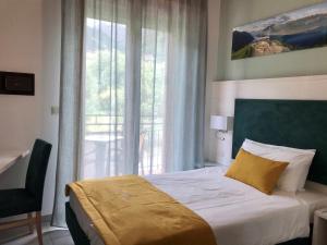 Postel nebo postele na pokoji v ubytování Hotel Limone