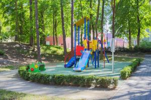 a playground with a slide in a park at Apartamenty Świnoujście - Wyspiańskiego 34e in Świnoujście