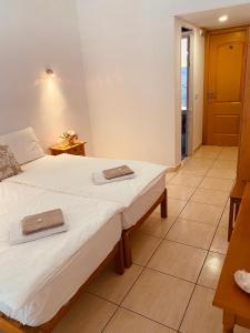 a bedroom with a bed with two towels on it at Hostal Villa Senese in Paguera
