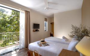 a bedroom with two beds and a large window at La Em Boutique Villa in Da Lat