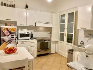 a kitchen with white cabinets and a counter top at CARDUCCI 13 B in Forte dei Marmi