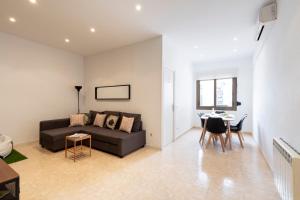 a living room with a couch and a table at The Camp Nou FCB Apartment in Barcelona