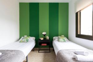 מיטה או מיטות בחדר ב-The Camp Nou FCB Apartment