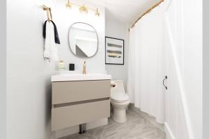 a white bathroom with a sink and a mirror at * Midcentury Modern Getaway * Prime Location * in Annapolis +43 photos