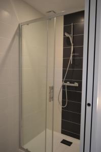 a shower with a glass door in a bathroom at Villa Uhaïna Hossegor in Hossegor +8 photos