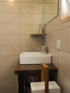 a bathroom with a sink and a mirror at Casa Boa Onda in Sagres